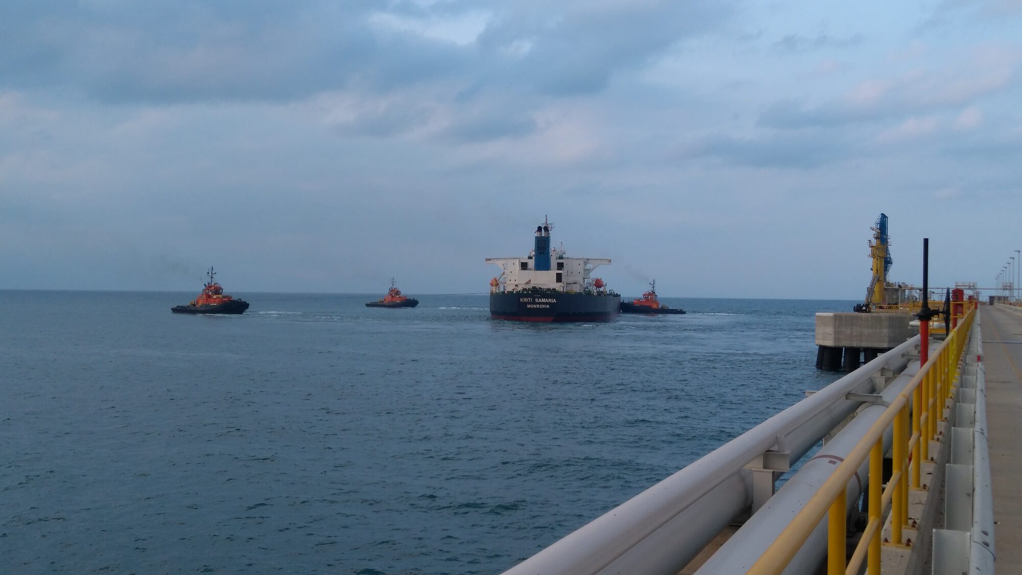 Tugs assisting a tanker on approach to berth